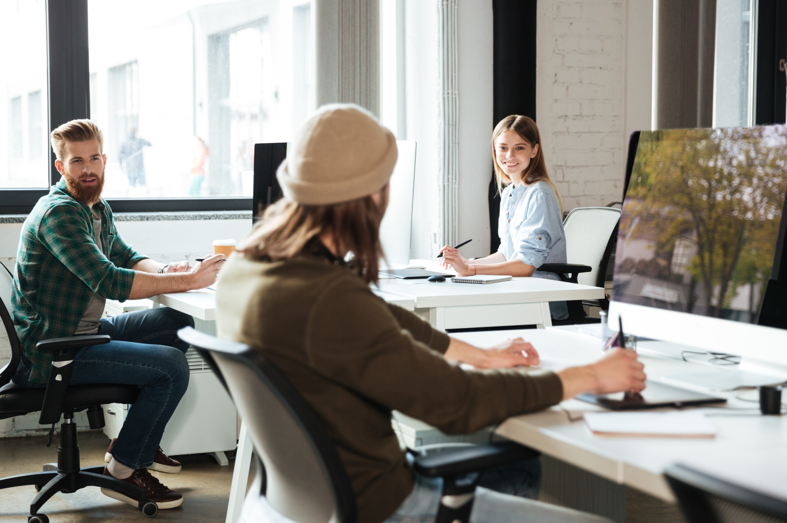 3 colleagues-work-office-using-computers-looking-aside.jpg