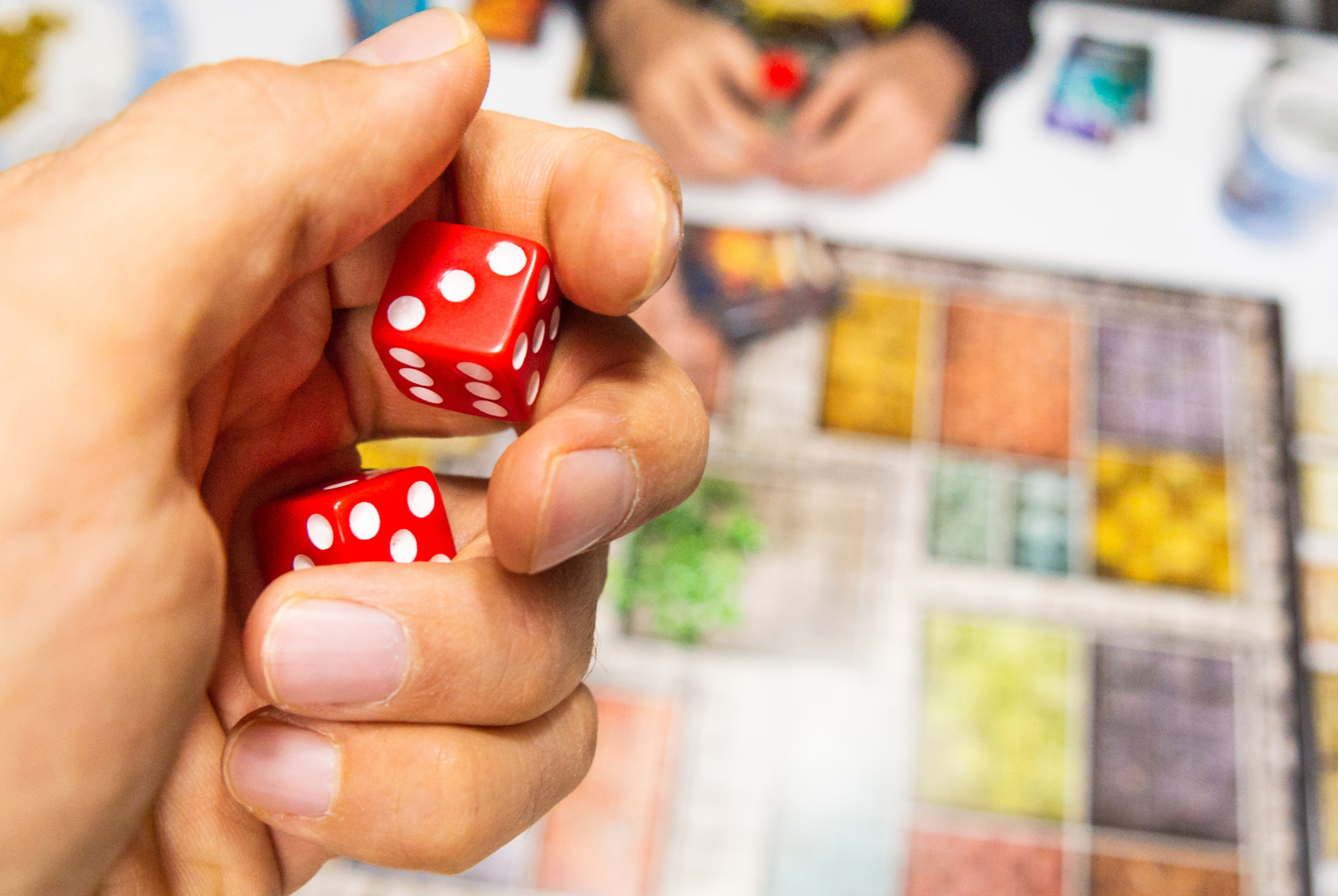 hand-with-red-dice-game-board-with-three.jpg