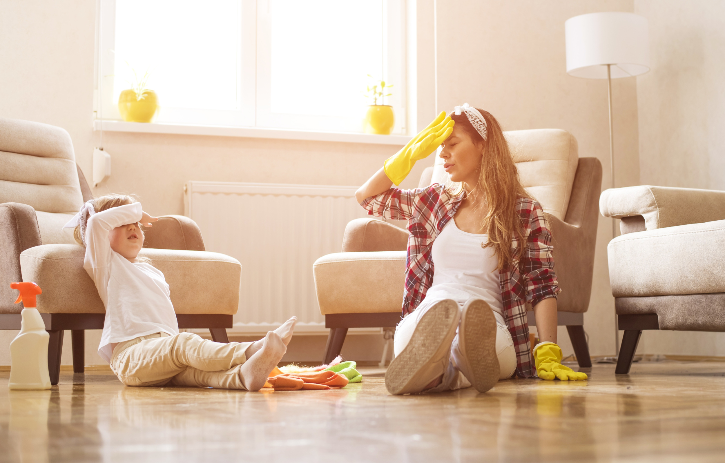 mother-daughter-feeling-exhausted-after-cleaning-home-together.jpg