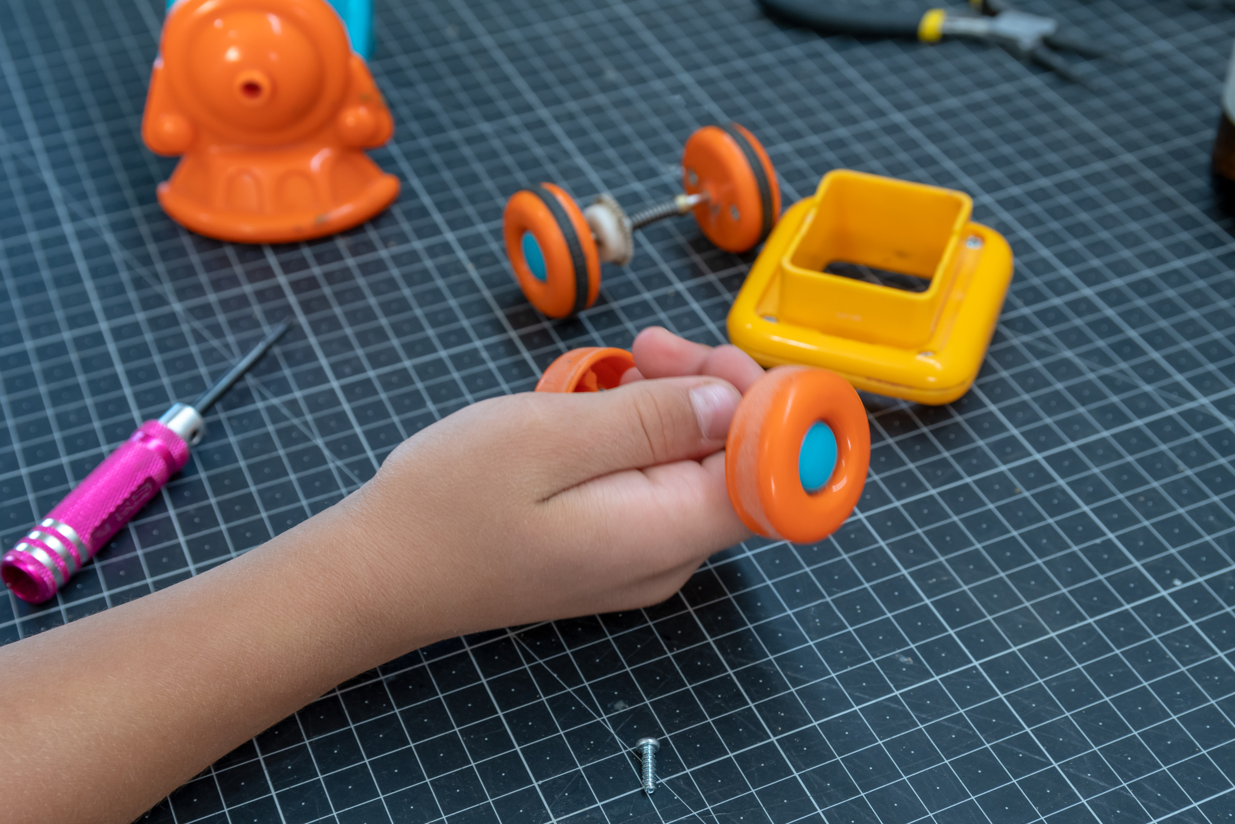 08 boy-is-repairing-his-toy-machine-photo-is-horizontal.jpg